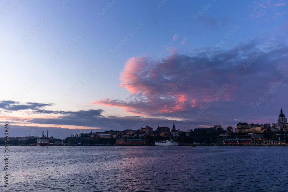 A red, colorful sunrise on the sea in the harbor of  Stockholm in winter  with the backdrop of the Old Town - 2