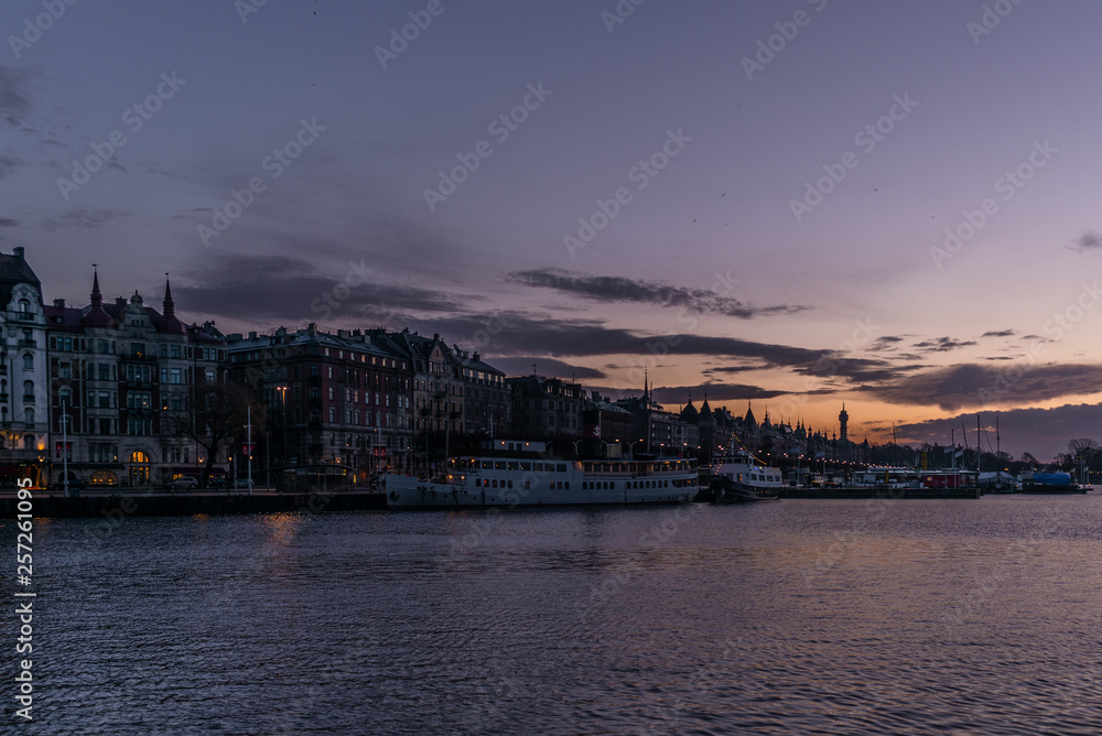 Ships in the harbor of  Stockholm during a colorful sunrise in winter  with the backdrop of the Old Town - 1