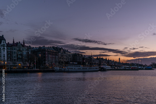 Ships in the harbor of Stockholm during a colorful sunrise in winter with the backdrop of the Old Town - 1