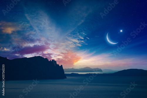 Ramadan Kareem religious background with rising crescent and star