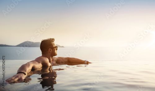 Portrait of a muscualar man relaxing in a tropical, hot water photo