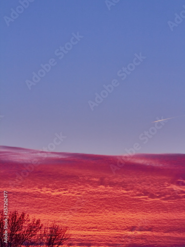 Sunset with red stratus clouds and blue sky