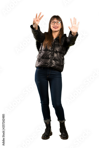 Full-length shot of Woman with glasses counting eight with fingers