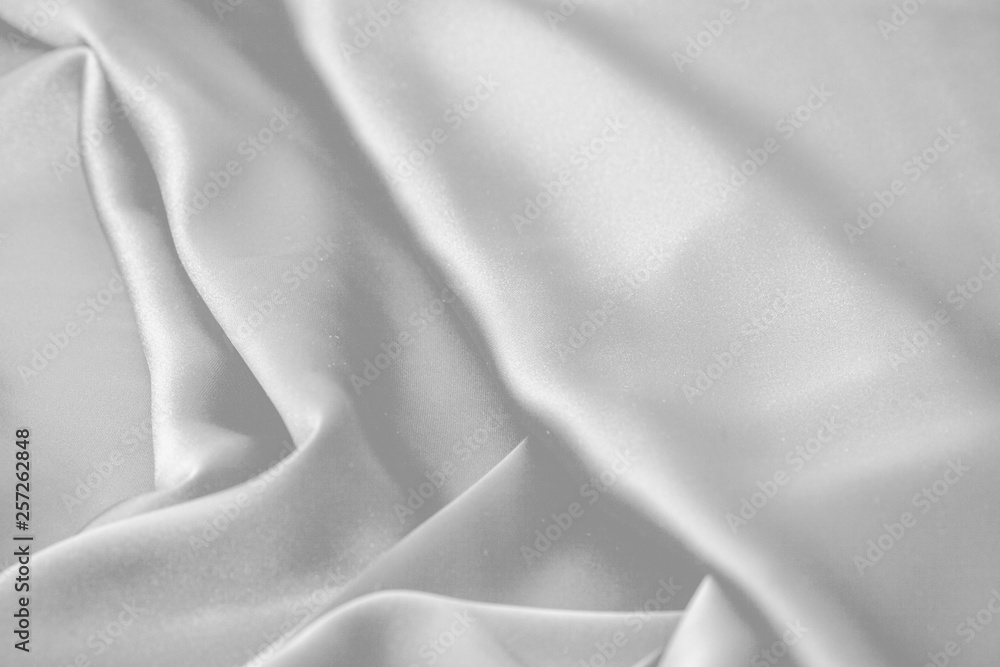 Fototapeta premium Rippled white silk fabric satin cloth waves background