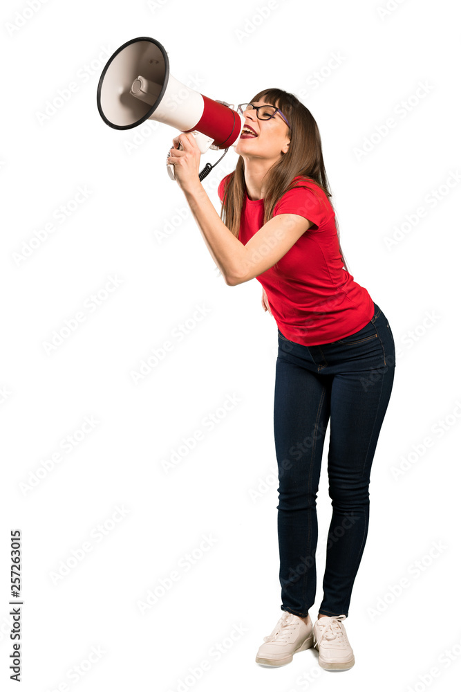 Full-length shot of Woman with glasses shouting through a megaphone Full-length shot of Woman with glasses shouting through a megaphone