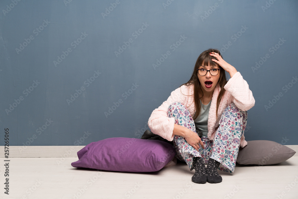 Woman in pajamas on the floor has just realized something and has intending the solution Woman in pajamas on the floor has just realized something and has intending the solution