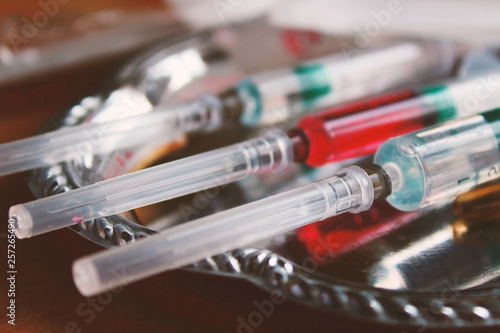 Syringes with needles on a tray. Close-up. Background. Texture.