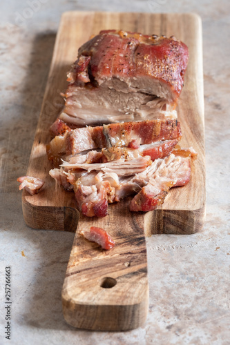 Baked carameled pork belly on a board photo