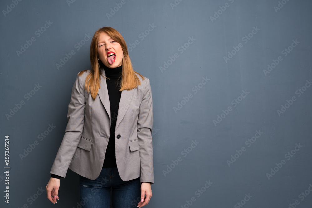 Redhead business woman showing tongue at the camera having funny look Redhead business woman showing tongue at the camera having funny look