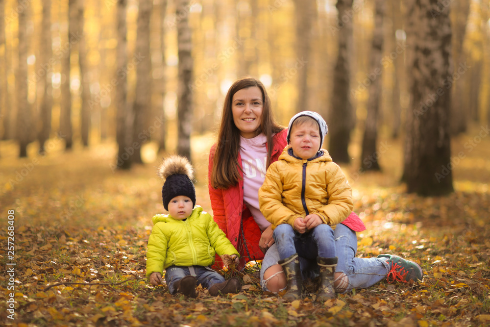 tender mother with two sons hugging. autumn park tender mother with two sons hugging. autumn park