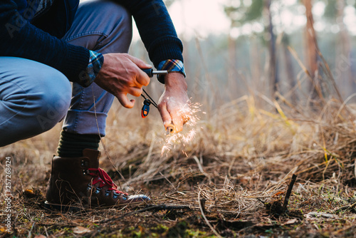Photos A man makes a fire with a flint
