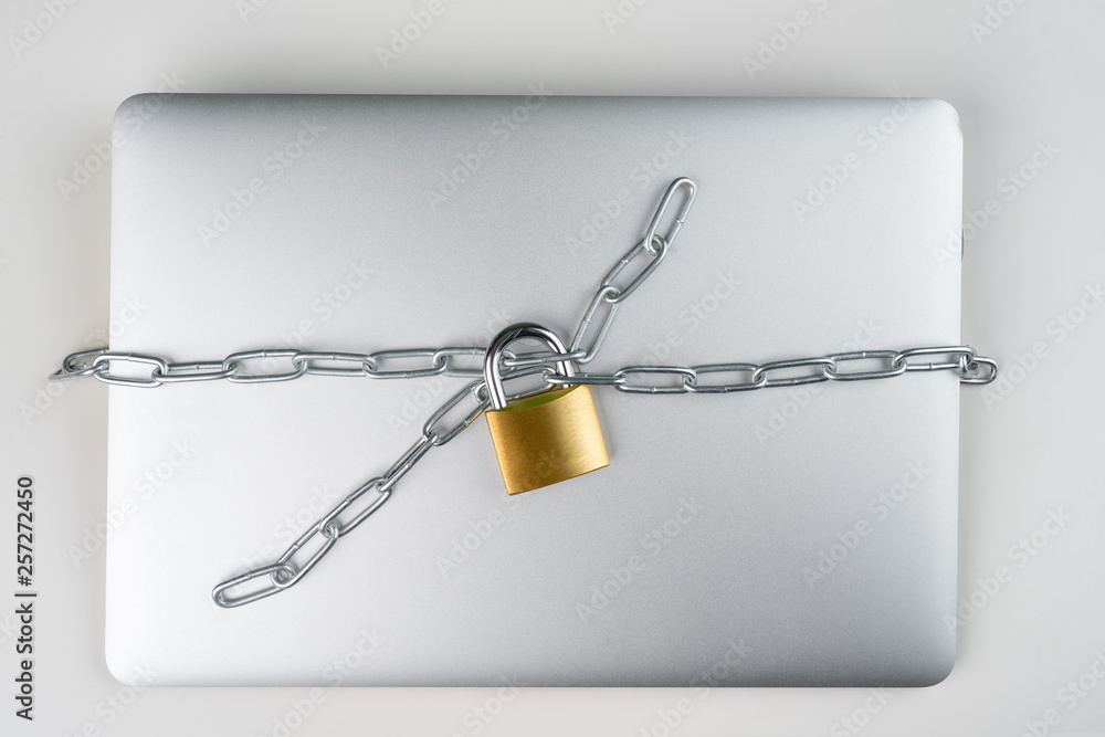 Padlock with chain on a laptop computer. Cyber security abstract concept. Padlock with chain on a laptop computer. Cyber security abstract concept.