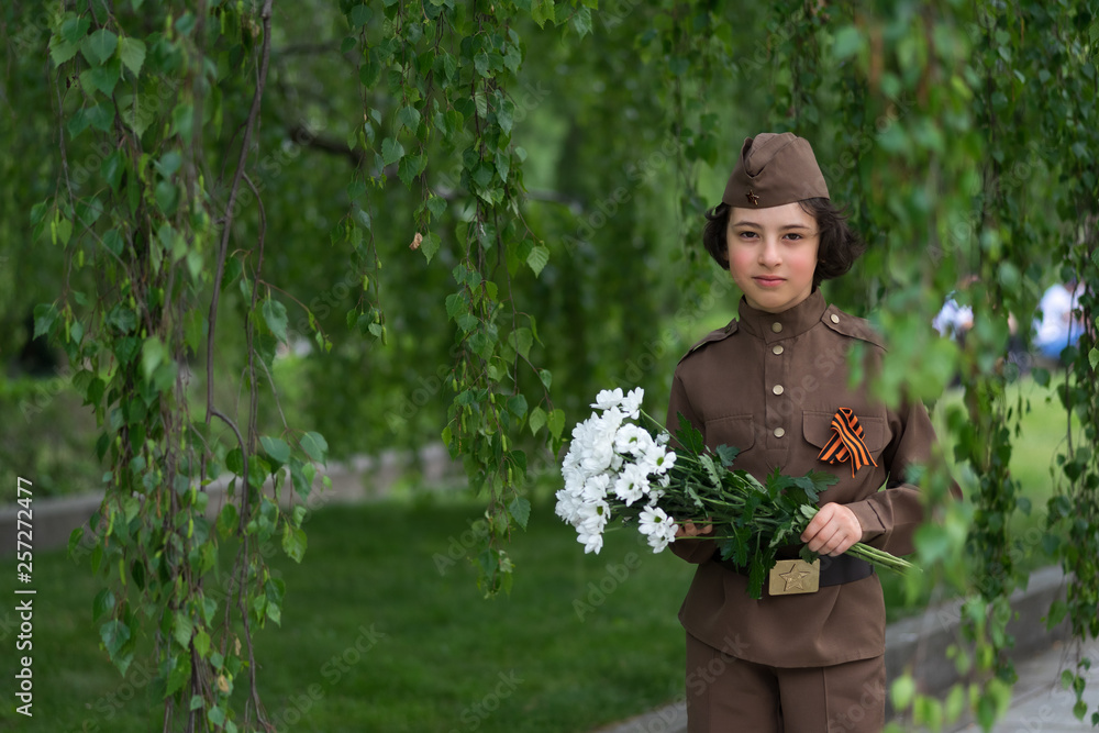 Portrait of a boy with flowers, in the uniform of a soldier of the Red Army during the Second World War. Portrait of a boy with flowers, in the uniform of a soldier of the Red Army during the Second World War.
