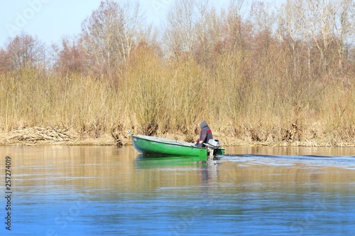 fisherman in a boat, spring