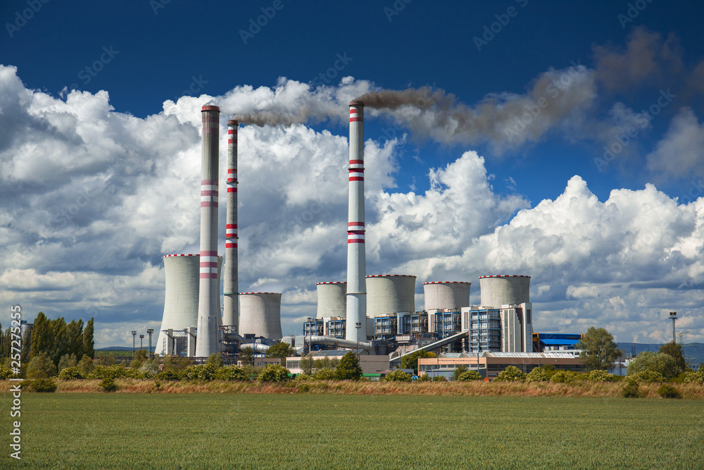 A coal-fired power station in the distance in agricultural landscape. Pocerady, Czech republic A coal-fired power station in the distance in agricultural landscape. Pocerady, Czech republic