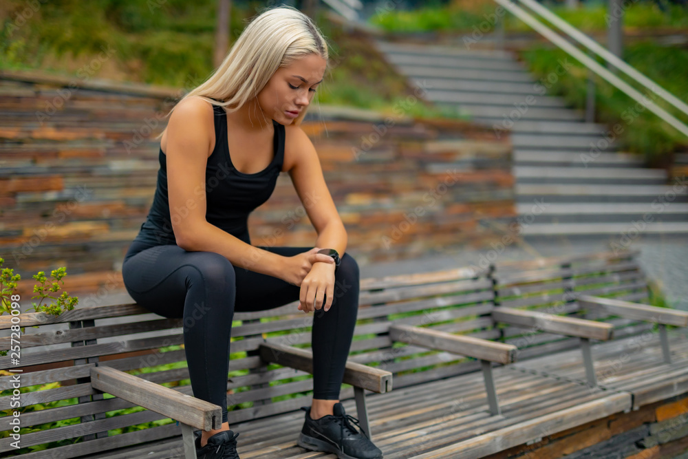 Fitness runner on mobile smart phone app tracking progress for motivation Fitness runner on mobile smart phone app tracking progress for motivation