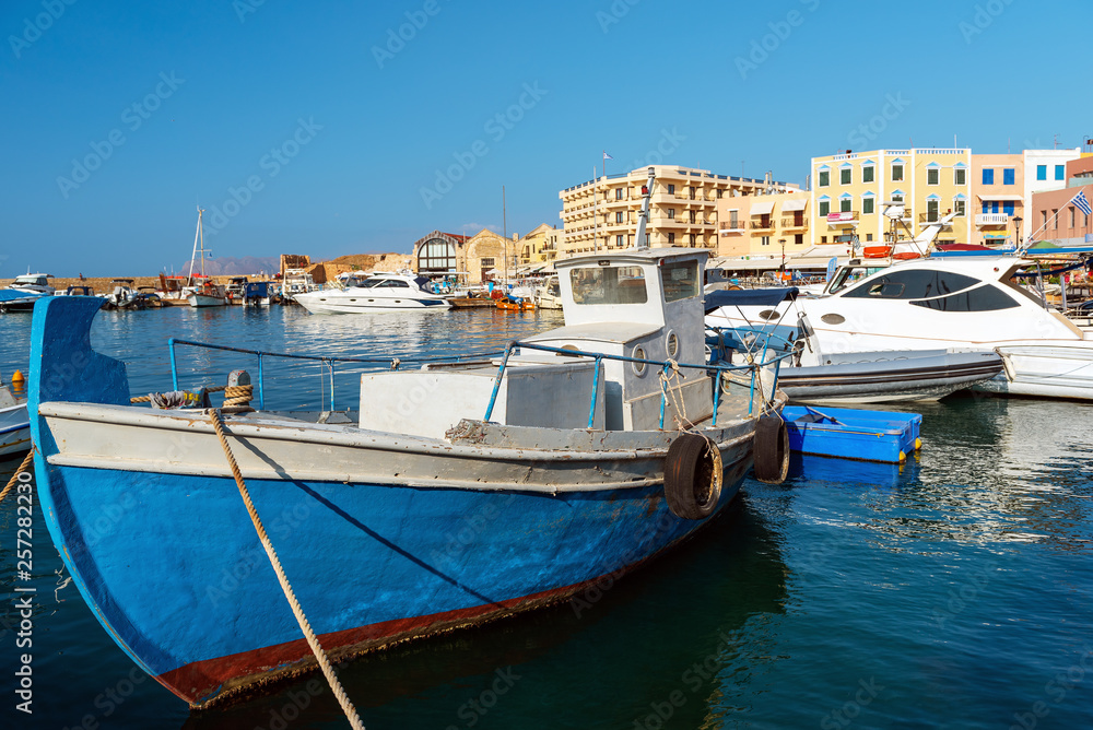 Traditional greek motorboat is moored near the pier. Crete island, Greece