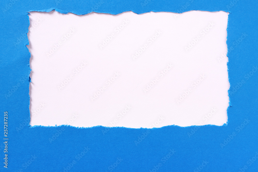 Obraz premium Torn blue paper white background border frame