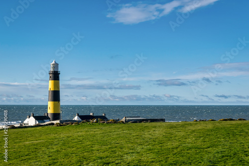 This is a picture of St John s Point Lighthouse  on the east coast of Northern Ireland on the Irish Sea.  It is one of Irelands many iconic coastal lighhouses