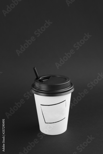 Kraft white cup for hot beverage on black background. photo