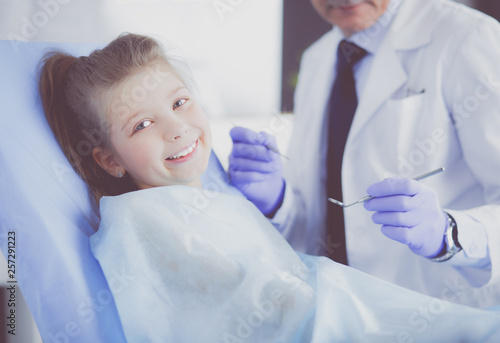 Little girl sitting in the dentists office