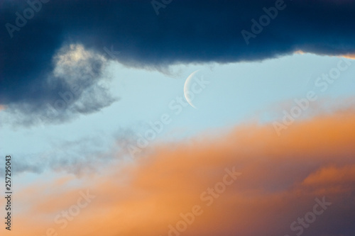 moon crescent on cloudy sky © Sebastian