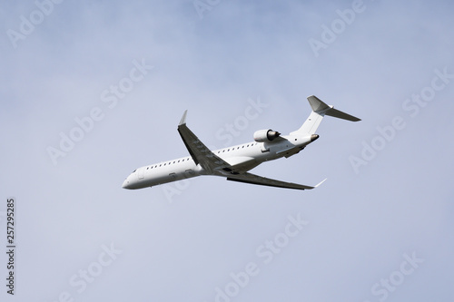 White airplane flying in cloudy sky