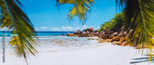 Tropical white sand beach on paradise island. Exotic Summer vacation travel relaxation holiday background concept. photo