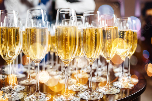 Champagne glasses on sparkling background.