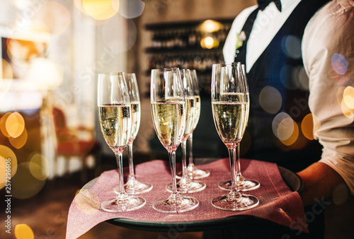 Champagne glasses on sparkling background.