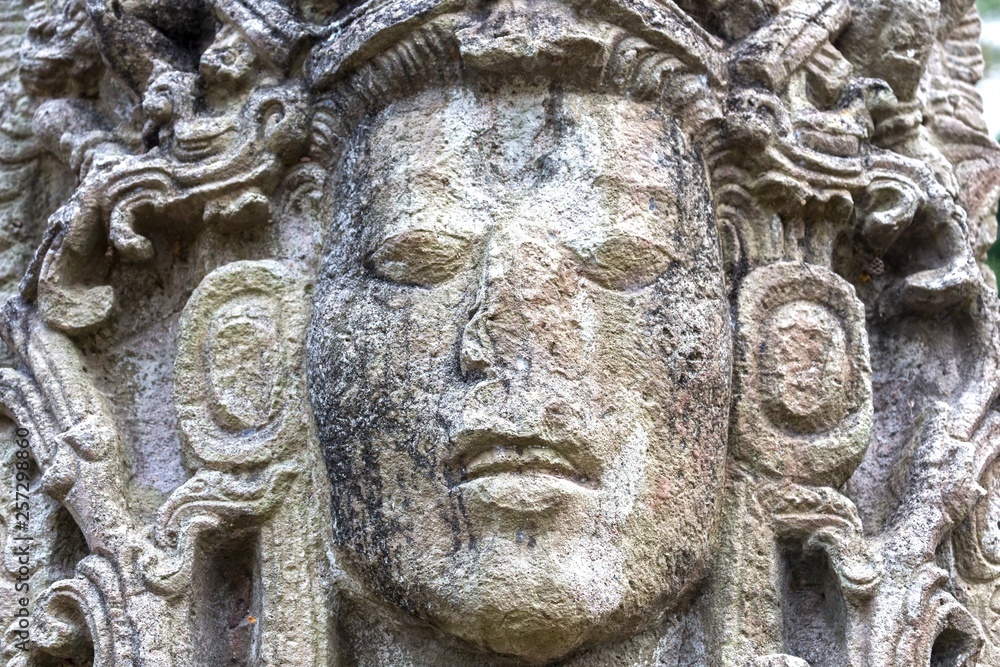 Mayan Face Carved in Stone Temple Building in World Famous Copan Ruins Archeological Site of ancient Maya Civilization, a UNESCO World Heritage Site in Honduras near Guatemala Border