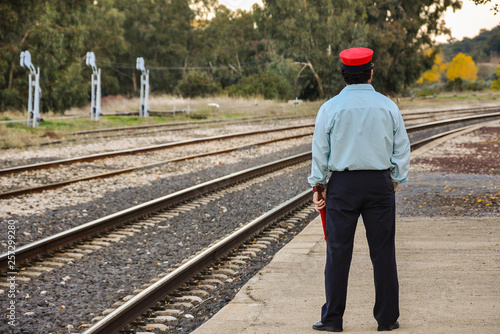 Station manager waiting for the train to pass, Caracollera, Ciudad Real, Spain.