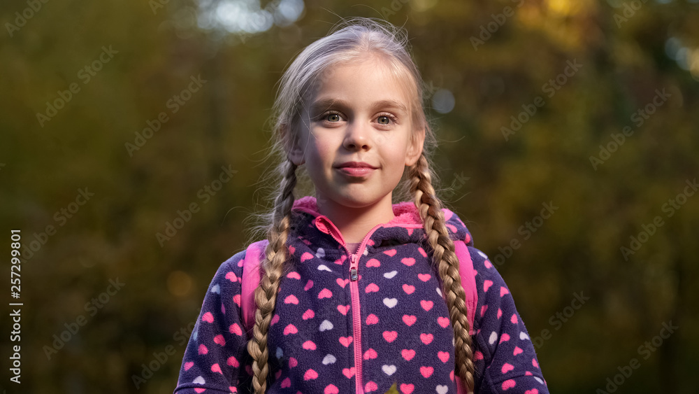 Beautiful school aged girl with two pigtails smiling and looking at camera Beautiful school aged girl with two pigtails smiling and looking at camera
