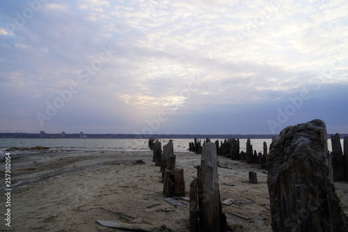 Kuyalnik estuary landscape. Kuyalnik liman salt lake in Odessa region of Ukraine. Wooden piles in a salt lake Kuyalnik estuary