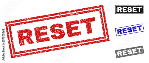 Grunge RESET rectangle stamp seals isolated on a white background. Rectangular seals with grunge texture in red, blue, black and gray colors.