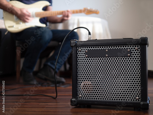 Obraz na płótnie Guitar amplifier close up with man playing guitar in the the background. w salonie