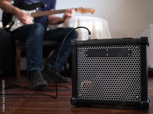 Obraz na płótnie Guitar amplifier close up with man playing guitar in the the background. w salonie