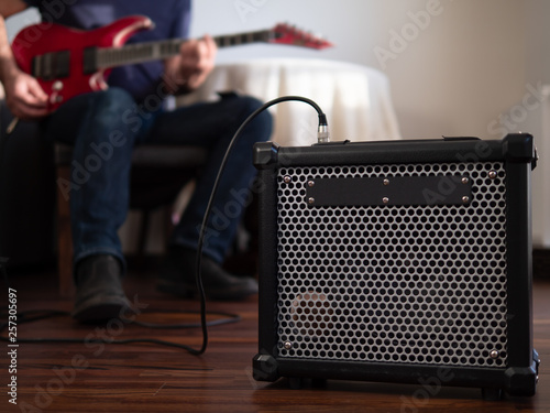 Obraz na płótnie Guitar amplifier close up with man playing guitar in the the background. w salonie