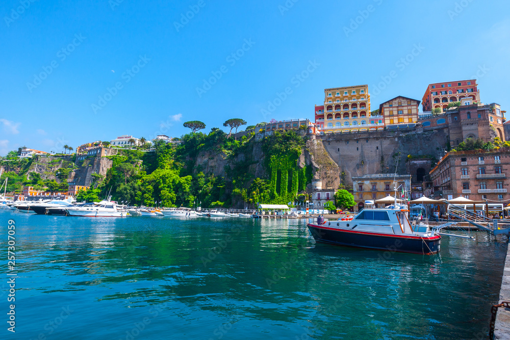 Seascape beautiful famous coastline. Yachts, boats and boats in the harbor. Seaside panoramic view of Sorrento, Naples, Campania, Italy.