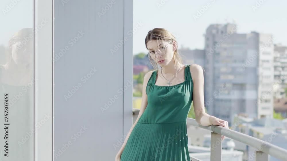 Young girl, model, posing in apartments and on the balcony Young girl, model, posing in apartments and on the balcony