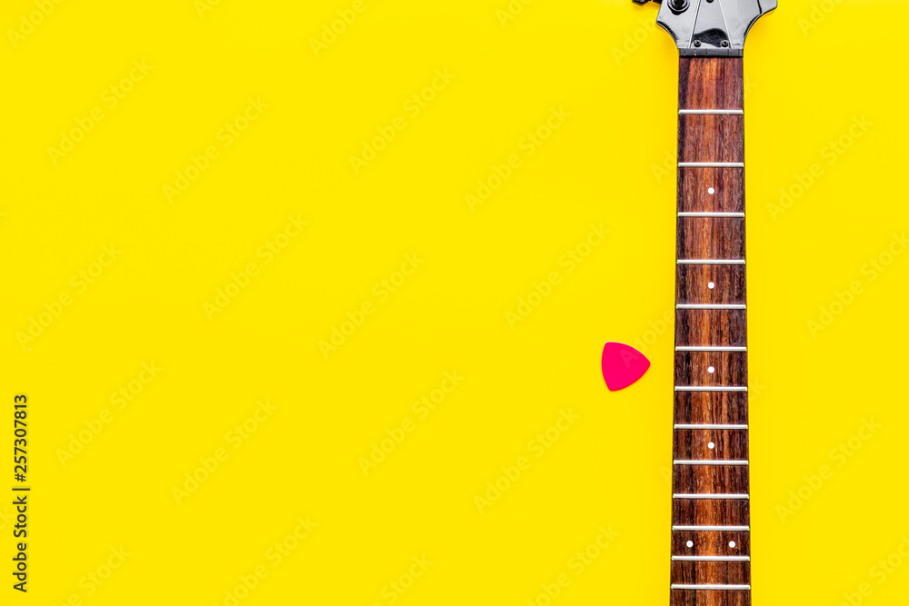 Fototapeta premium Musician work place with guitar on yellow background top view mock up