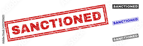 Grunge SANCTIONED rectangle stamp seals isolated on a white background. Rectangular seals with grunge texture in red, blue, black and gray colors.