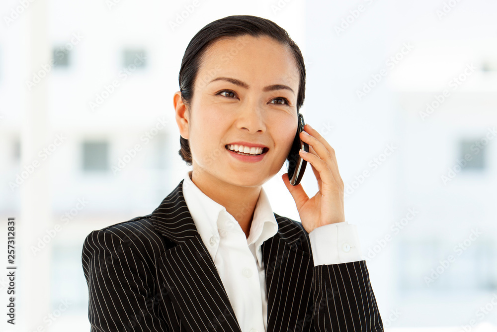 asian woman on the phone using smartphone - corporate business communication asian woman on the phone using smartphone - corporate business communication