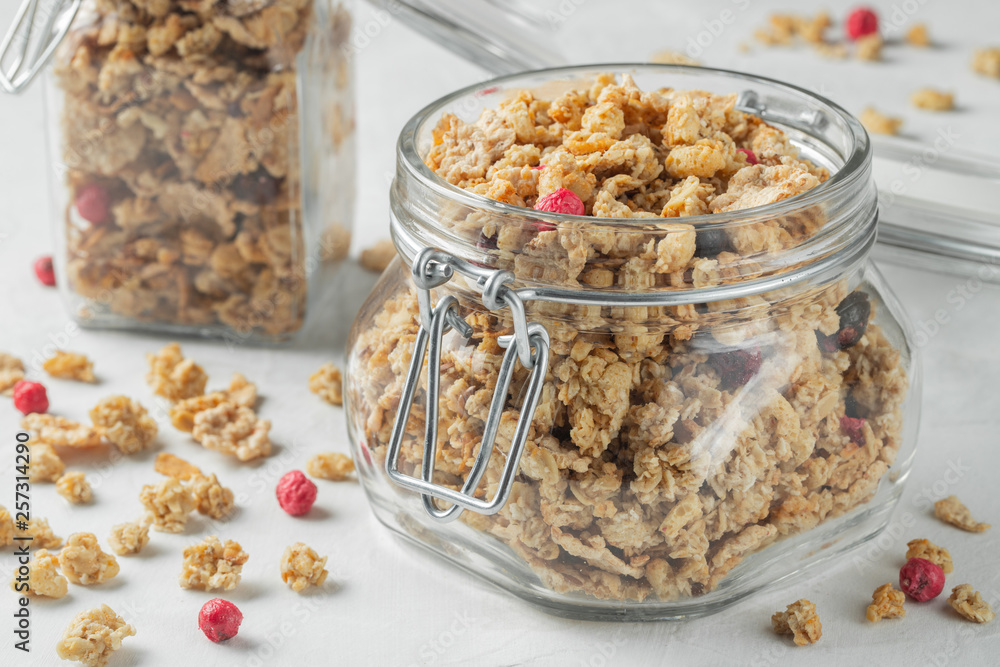 Homemade granola with berries in a mason jar. Homemade granola with berries in a mason jar.