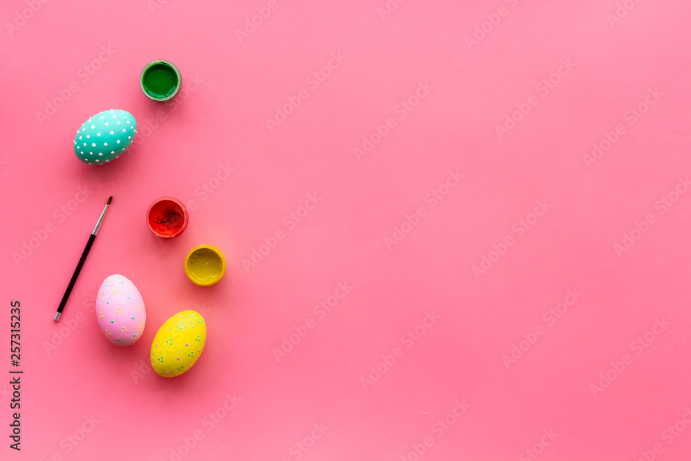 eggs with colorful paint for easter tradition on pink background top view mockup