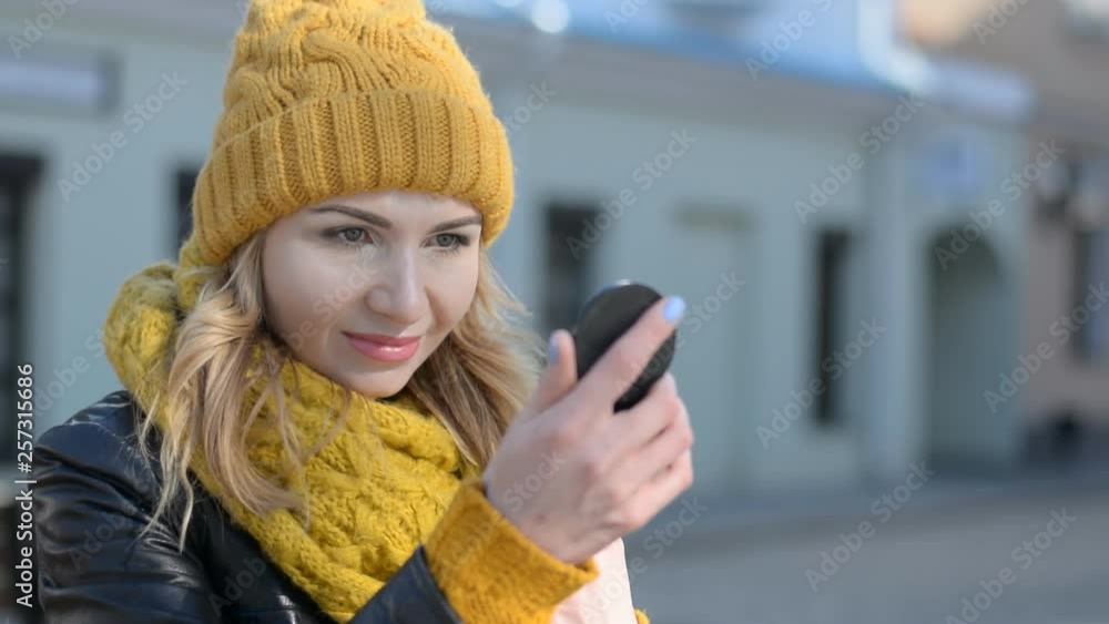 Young and very beautiful girl fixing Makeup on a Face in city street HD stock footage Young and very beautiful girl fixing Makeup on a Face in city street HD stock footage