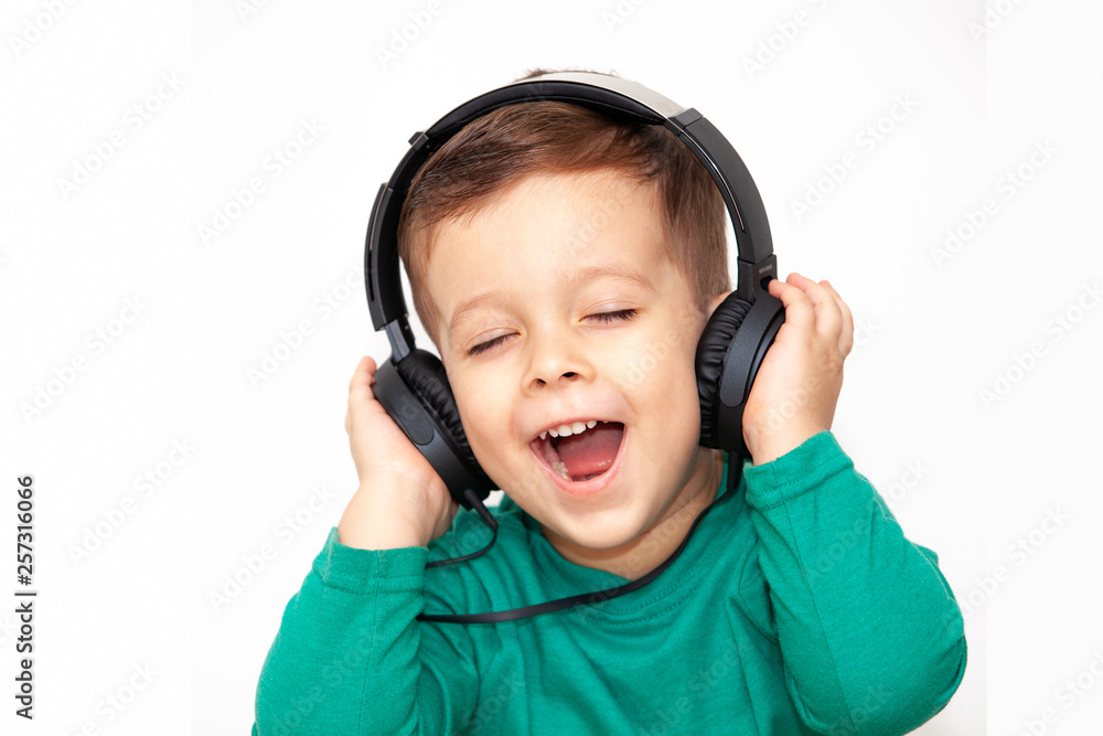 emotional boy in headphones on a light background emotional boy in headphones on a light background
