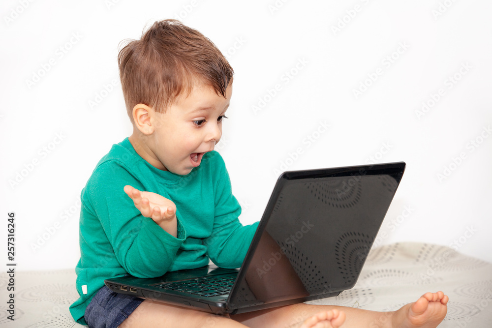 emotional boy with laptop on a light background emotional boy with laptop on a light background