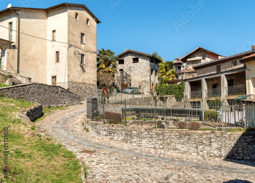 View of the small village Masciago Primo of Valcuvia with narrow streets and stone houses, located in the province of Varese, Lombardy, Italy © EleSi