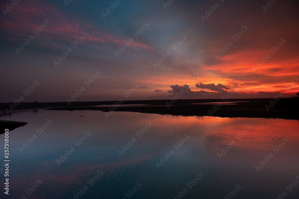 Colorful Sunset Reflection on lake at Pengklik Samas Indonesia